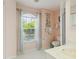 Bathroom featuring tiled floor, window with blinds, and decorative wall art at 1110 Southlake Ct, Venice, FL 34285