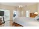 Comfortable bedroom with a ceiling fan, wood floors, and ample natural light at 1110 Southlake Ct, Venice, FL 34285