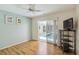 Bedroom with ceiling fan and sliding door access to screened-in lanai and pool at 1110 Southlake Ct, Venice, FL 34285