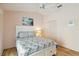 Cozy bedroom features wood floors, ceiling fan, and closet for ample storage at 1110 Southlake Ct, Venice, FL 34285