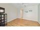 Simple bedroom with wood floors, ceiling fan, and beachy accents at 1110 Southlake Ct, Venice, FL 34285
