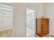View from bedroom showcasing a walk-in closet and the ensuite bathroom with white cabinetry at 1110 Southlake Ct, Venice, FL 34285