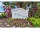 Welcoming community sign for Lakeside Woods South, surrounded by lush landscaping and colorful flowers at 1110 Southlake Ct, Venice, FL 34285