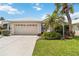 Charming single-story home with a two-car garage, lush landscaping, and well-manicured lawn at 1110 Southlake Ct, Venice, FL 34285
