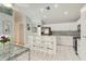 Clean kitchen with modern stainless steel appliances, white cabinetry, and a convenient breakfast bar seating area at 1110 Southlake Ct, Venice, FL 34285