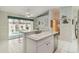 Bright kitchen featuring a breakfast bar and a serene view of the pool area, combining functionality with relaxation at 1110 Southlake Ct, Venice, FL 34285