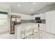 Bright kitchen with breakfast bar, stainless steel refrigerator, and ample storage, designed for efficiency and style at 1110 Southlake Ct, Venice, FL 34285