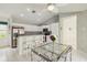 Bright kitchen featuring white cabinetry, stainless steel appliances, and a dining area with seating at 1110 Southlake Ct, Venice, FL 34285