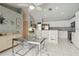 Open-concept kitchen featuring a breakfast bar, white cabinetry, and stainless steel appliances, perfect for casual dining at 1110 Southlake Ct, Venice, FL 34285