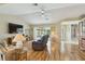 Spacious living room with hardwood floors, providing access to the pool area and other parts of the house at 1110 Southlake Ct, Venice, FL 34285
