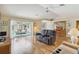 Cozy living room with hardwood floors, plush seating, and sliding glass doors to the patio at 1110 Southlake Ct, Venice, FL 34285