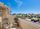 Balcony view overlooking a community pool, trees, and parking lot on a sunny day at 1164 Beachcomber Ct # 19, Osprey, FL 34229