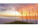 A vibrant beach sunset with tall grass in the foreground and calming ocean view at 1164 Beachcomber Ct # 19, Osprey, FL 34229