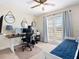 Bedroom with office space, ceiling fan, and a glass door to the outside at 1164 Beachcomber Ct # 19, Osprey, FL 34229