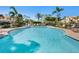 Community pool with plenty of lounge chairs, umbrellas and lush landscaping, perfect for relaxing and enjoying the sun at 1164 Beachcomber Ct # 19, Osprey, FL 34229