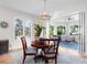 Elegant dining room with wood table, chandelier, plantation shutters and sliding door to Florida room at 1164 Beachcomber Ct # 19, Osprey, FL 34229