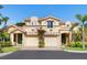 Exterior elevation of a two-story home shows two garage doors and a well maintained lawn at 1164 Beachcomber Ct # 19, Osprey, FL 34229