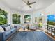Bright Florida room with large windows, comfortable seating, a ceiling fan, and tiled floors at 1164 Beachcomber Ct # 19, Osprey, FL 34229