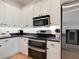 Kitchen features stainless steel appliances, white cabinets, and dark countertops at 1164 Beachcomber Ct # 19, Osprey, FL 34229