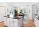 Kitchen with island, stainless appliances, tile floors, ample natural light, and an open layout at 1164 Beachcomber Ct # 19, Osprey, FL 34229