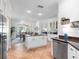Modern kitchen with stainless steel appliances, granite countertops, a large island, and an open layout at 1164 Beachcomber Ct # 19, Osprey, FL 34229