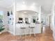 Eat-in kitchen area with granite counters, stylish stools and open views to other parts of the home at 1164 Beachcomber Ct # 19, Osprey, FL 34229