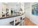 Open concept kitchen with granite counters, breakfast bar, stainless appliances, and adjacent dining area at 1164 Beachcomber Ct # 19, Osprey, FL 34229