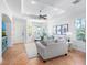 Inviting living room with ample seating, tile floors, bay window, ceiling fan, and neutral colors at 1164 Beachcomber Ct # 19, Osprey, FL 34229