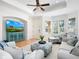 Cozy living room with comfortable seating, entertainment center, plantation shutters, and tile flooring at 1164 Beachcomber Ct # 19, Osprey, FL 34229