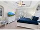 Bright main bedroom with white furniture, ceiling fan, neutral colors, and outside views from a large window at 1164 Beachcomber Ct # 19, Osprey, FL 34229