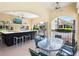Outdoor kitchen area with a built-in bar, grill, stainless appliances, ceiling fans and a mounted television at 1164 Beachcomber Ct # 19, Osprey, FL 34229