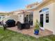Covered patio with outdoor table and chairs, grill, and potted plant on a sunny day at 1164 Beachcomber Ct # 19, Osprey, FL 34229