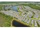 Aerial view of neighborhood showing the homes and natural surrounding landscape at 11954 Tempest Harbor Loop, Venice, FL 34292