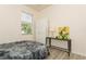 Cozy bedroom with natural light, a bed with grey furry bedding, and side table at 11954 Tempest Harbor Loop, Venice, FL 34292