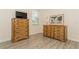 Bedroom featuring wood-look flooring, natural light and wooden dressers at 11954 Tempest Harbor Loop, Venice, FL 34292