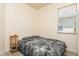Spare bedroom featuring gray furry bedding, bedside table and natural light at 11954 Tempest Harbor Loop, Venice, FL 34292