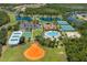 Aerial view of community amenities, featuring pool, clubhouse, tennis courts, and recreational fields at 11954 Tempest Harbor Loop, Venice, FL 34292