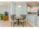 Cozy dining area featuring a glass-top table, four chairs, and neutral decor at 11954 Tempest Harbor Loop, Venice, FL 34292