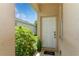 Inviting front entrance with a white door, landscaping and a cozy front porch at 11954 Tempest Harbor Loop, Venice, FL 34292