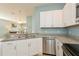 Well-appointed kitchen featuring stainless steel appliances, granite countertops, and bright cabinets at 11954 Tempest Harbor Loop, Venice, FL 34292