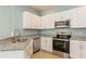 Modern kitchen featuring stainless steel appliances, granite countertops, and plenty of storage at 11954 Tempest Harbor Loop, Venice, FL 34292