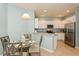 Modern kitchen featuring stainless steel appliances, white cabinets, and granite countertops at 11954 Tempest Harbor Loop, Venice, FL 34292