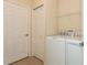Well-lit laundry room with appliances and easy access storage at 11954 Tempest Harbor Loop, Venice, FL 34292