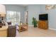 Cozy living room featuring tile floors, sliding glass doors and comfortable seating at 11954 Tempest Harbor Loop, Venice, FL 34292