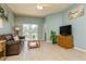 Inviting living room showcasing tile floors, neutral walls and access to the outdoors at 11954 Tempest Harbor Loop, Venice, FL 34292