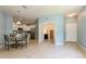Open-concept living space with a dining area and kitchen, enhanced by natural light at 11954 Tempest Harbor Loop, Venice, FL 34292