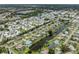 Aerial view of a home located on a canal with a pool and water view at 120 Hourglass Dr, Venice, FL 34293