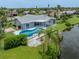 Stunning aerial view featuring a private pool, waterfront access, and beautiful landscaping for outdoor enjoyment at 120 Hourglass Dr, Venice, FL 34293