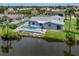 Waterfront home with a screened pool and lush landscaping with view of the canal at 120 Hourglass Dr, Venice, FL 34293