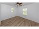 Bedroom featuring wood floors and two windows offering plenty of natural light at 120 Hourglass Dr, Venice, FL 34293